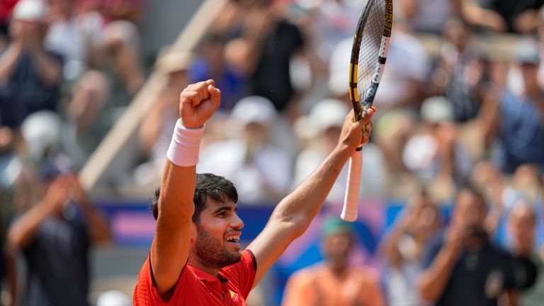 Carlos Alcaraz of Spain celebrates after defeating Felix Auger-Aliassime of...