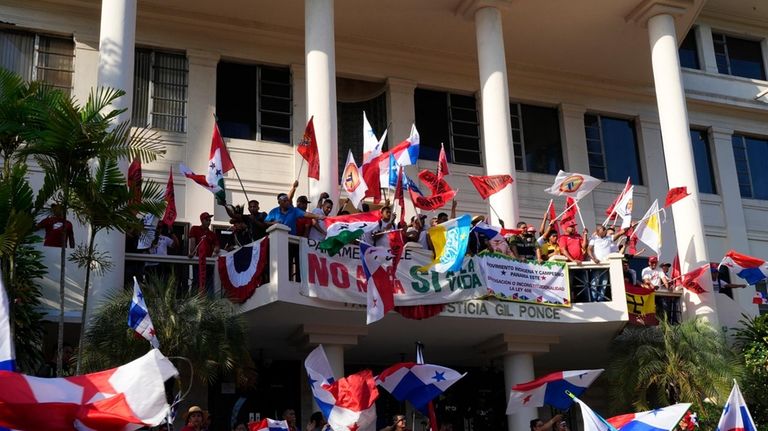 Protesters celebrate as they learn that Panama's Supreme Court has...