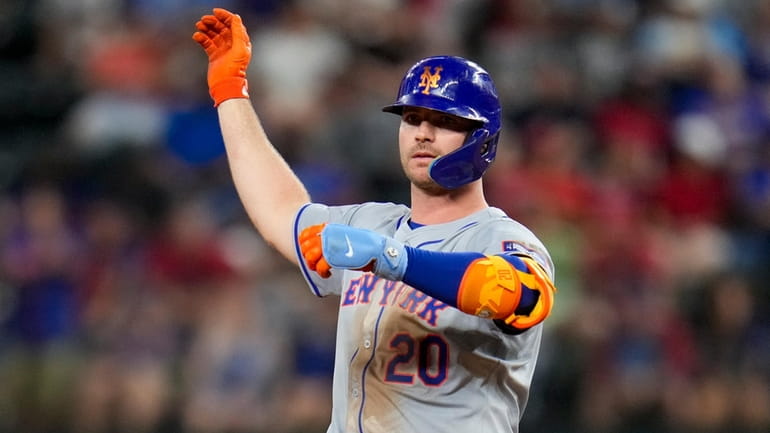 Mets' Pete Alonso reacts after hitting an RBI double to...