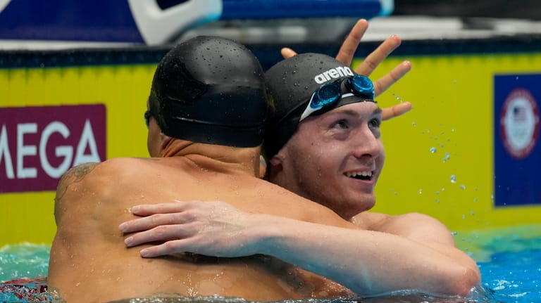 Caeleb Dressel and Chris Guiliano embrace after the Men's 50...