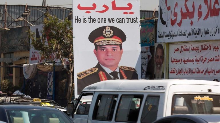 A huge placard depicting Egyptian army chief Abdel-Fattah el-Sissi is...