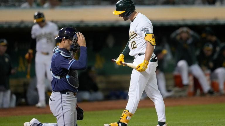 Oakland Athletics' Max Schuemann (12) reacts after striking out next...