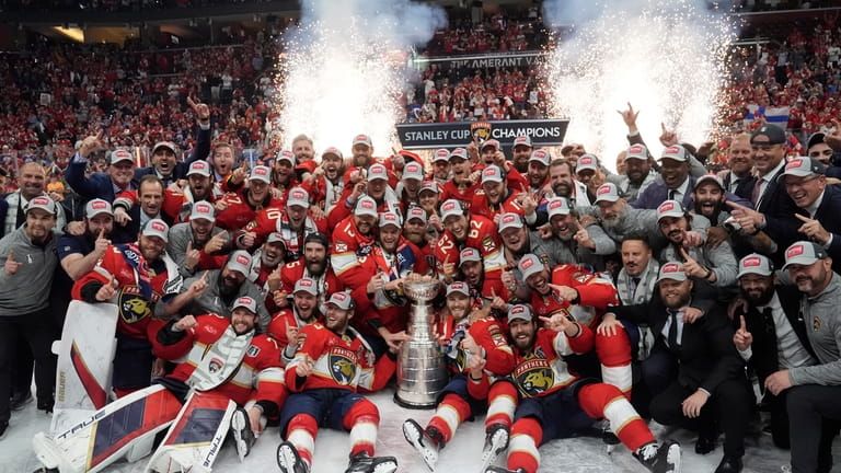 The Florida Panthers team poses with the Stanley Cup trophy...