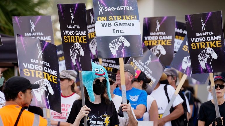 Actor Sena Bryer, second from left, joins other demonstrators in...