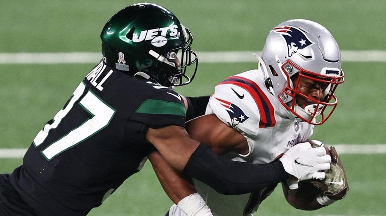 Jakobi Meyers of the Patriots makes a catch as Bryce...