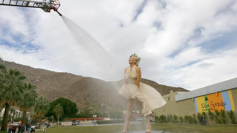 The "Forever Marilyn" sculpture gets a shower from the Palm...