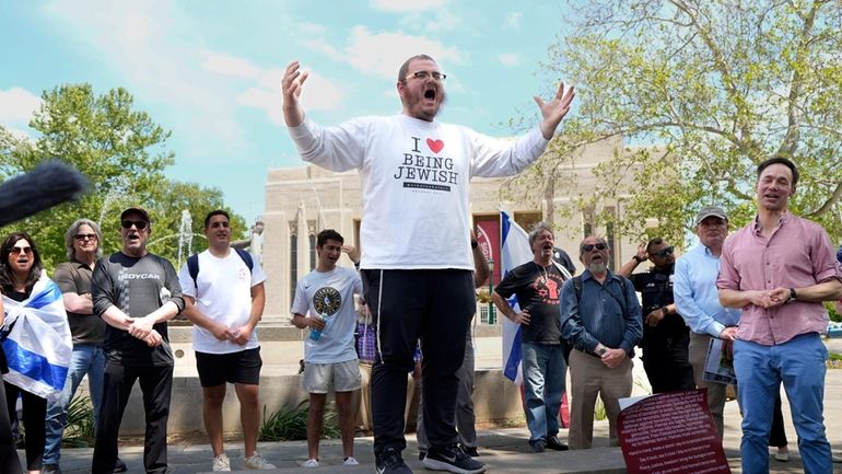 Rabbi Levi Cunin, with Chabad on Campus, speaks during a...