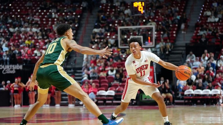 UNLV guard Dedan Thomas Jr. (11) controls the ball as...