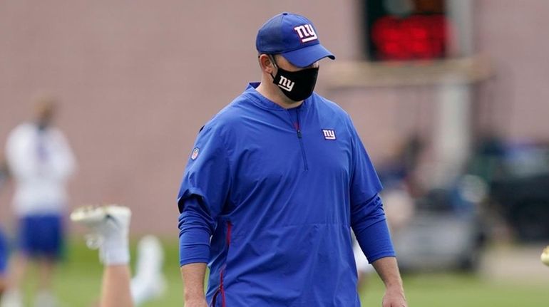 Giants head coach Joe Judge talks to his quarterbacks during...