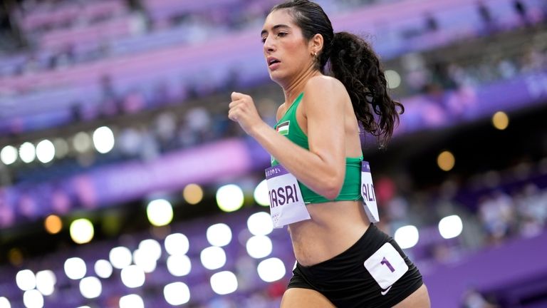 Layla Almasri, of Palestine, competes in a women's 800 meters...