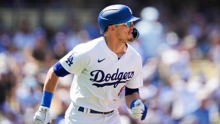 Los Angeles Dodgers' Kiké Hernández runs the bases after hitting...