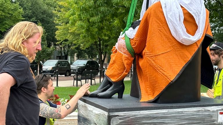 Workers finish installing a statue of Vel Phillips, Wisconsin's first...