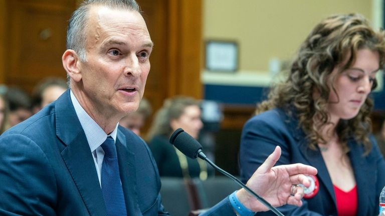 Allison Schmitt, former Olympic athlete, right, listens as Travis Tygart,...