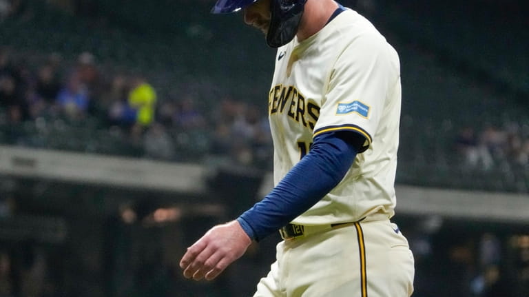 Milwaukee Brewers' Rhys Hoskins leaves the game after hitting a...