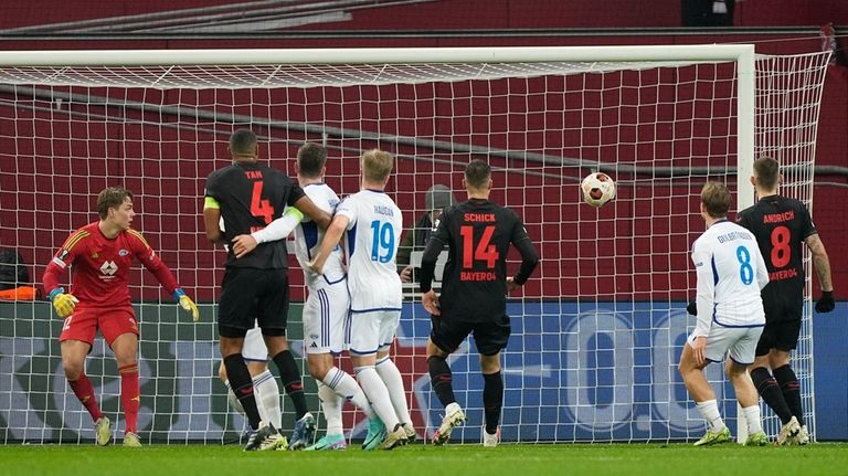 Players watch the ball in the net, after Leverkusen's Edmond...