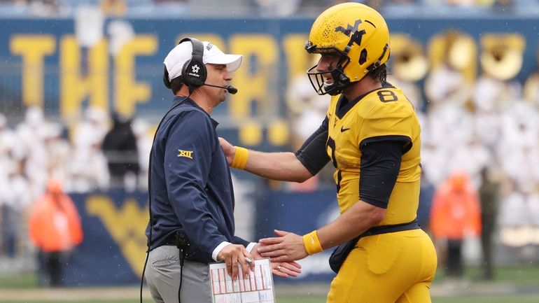 West Virginia head coach Neal Brown and quarterback Nicco Marchiol...