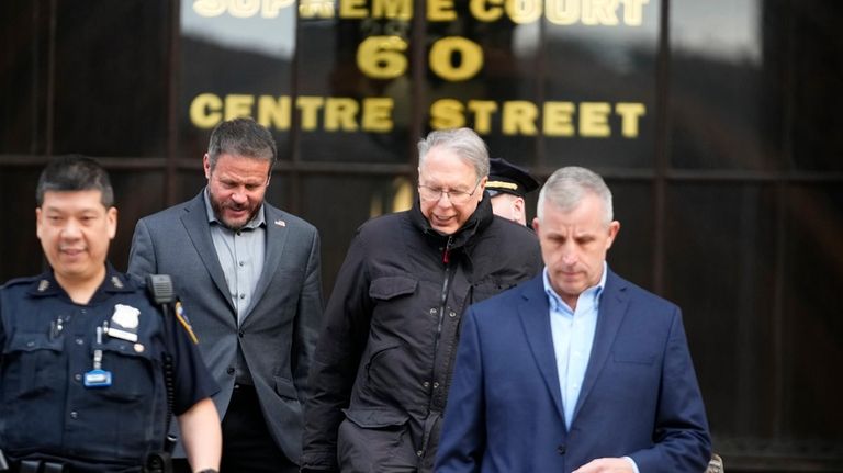 Wayne LaPierre, left, CEO of the National Rifle Association, leaves...