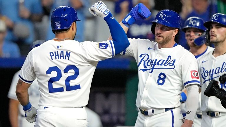 Kansas City Royals' Tommy Pham (22) celebrates with Robbie Grossman...