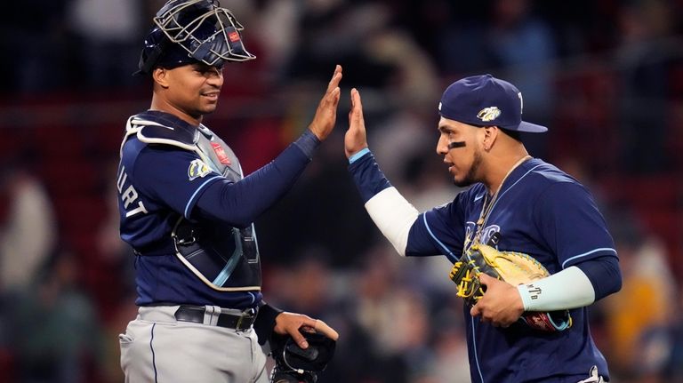 Tampa Bay Rays' Isaac Paredes, right, celebrates with catcher Christian...