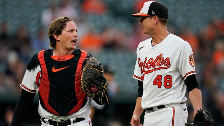 Baltimore Orioles starting pitcher Kyle Gibson (48) talks to catcher...