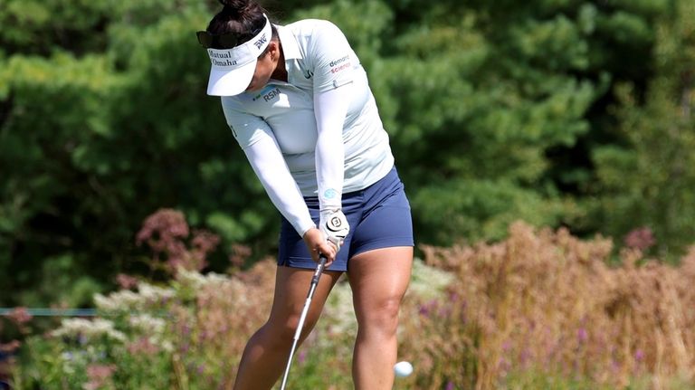 Megan Khang of the United States tees off on the...