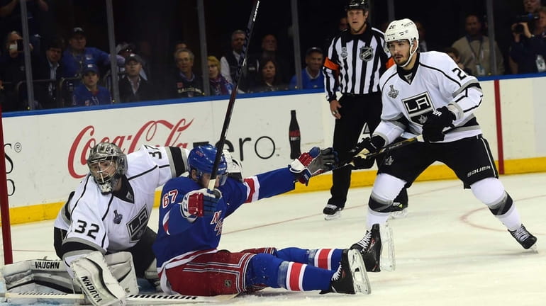 Rangers left wing Benoit Pouliot collides with Los Angeles Kings...