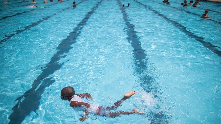 Children cool off at the Hamilton Fish pool, July 18,...