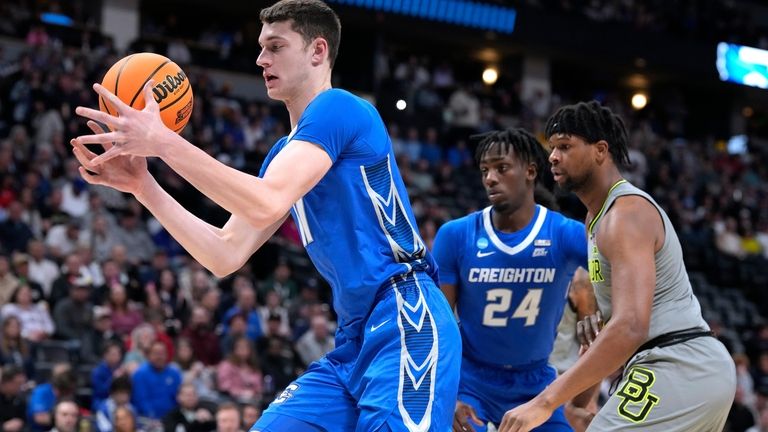 Creighton center Ryan Kalkbrenner, left, pulls in a rebound in...