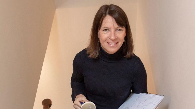 Lisa Hendrickson commutes up the stairs in her Port Washington home.