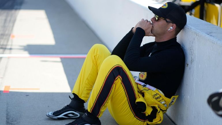 Scott McLaughlin, of New Zealand, sits along pit lane during...