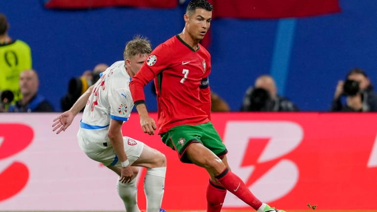 Portugal's Cristiano Ronaldo, right, and Czech Republic's David Jurasek challenge...