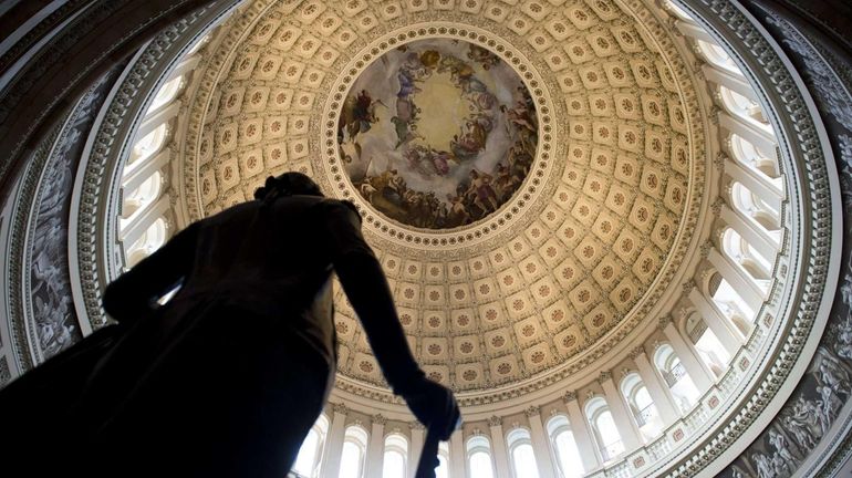 A statue of George Washington is seen in the Rotunda...