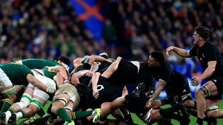 Players scrum during the Rugby World Cup final match between...