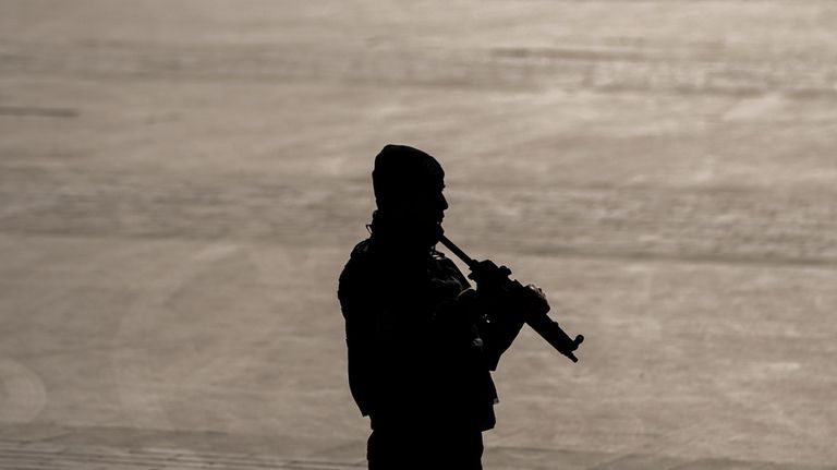 Security officers check the site where two attackers were killed...