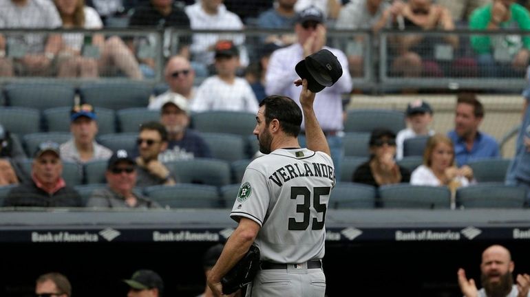 Houston Astros starting pitcher Justin Verlander tips his cap as...