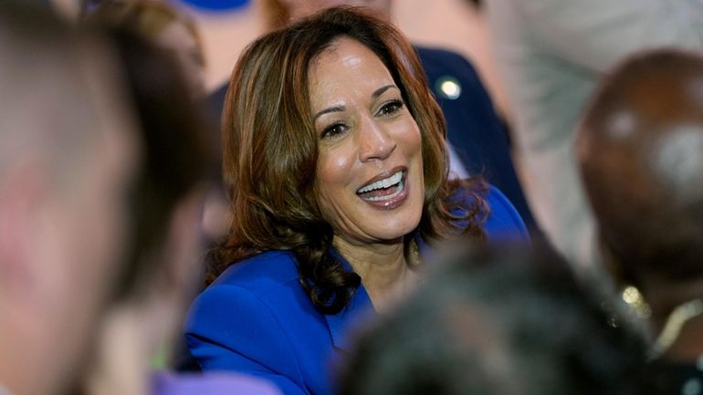 Democratic presidential nominee Vice President Kamala Harris greets supporters at...