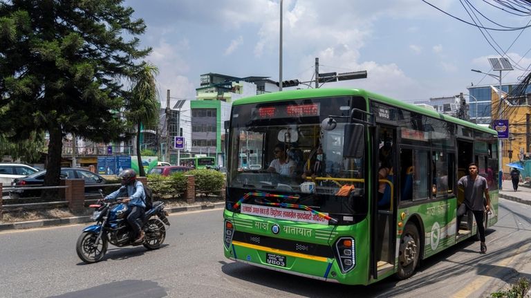 Conductor of an electric passenger bus calls to attract attention...