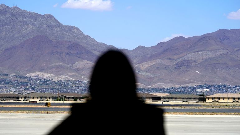 Vice President Kamala Harris stands in front of mountains during...