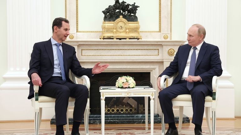 Syrian President Bashar Assad, left, speaks with Russian President Vladimir...