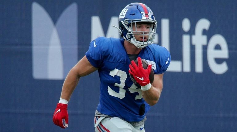 Giants running back Sandro Platzgummer runs with the ball during...