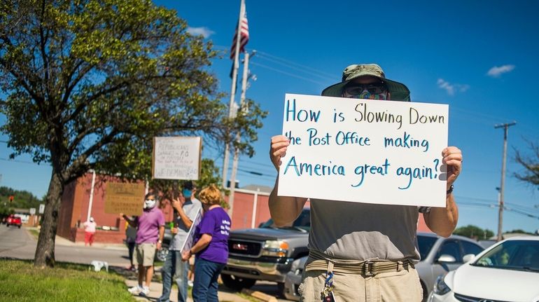 Demonstrators gather in Midland, Mich., on Aug. 11 to rally...