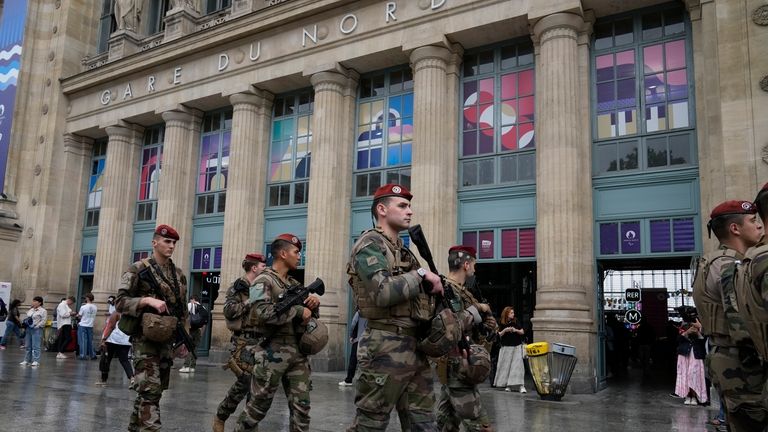 Soldiers patrol outside Gare du Nord train station at the...