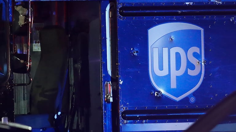 Bullet holes are seen around the UPS logo on a...