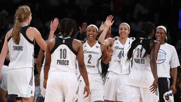 New York Liberty players celebrate during a timeout in the...