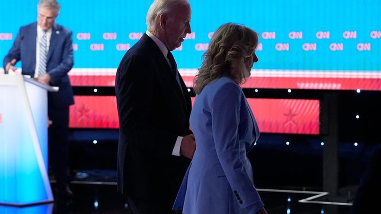 President Joe Biden, left, and first lady Jill Biden depart...