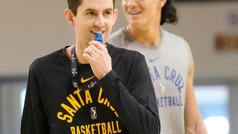 Santa Cruz Warriors coach Nicholas Kerr, foreground, walks on the...