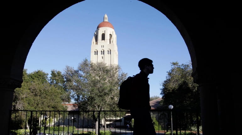 A Stanford University student walks in front of Hoover Tower...