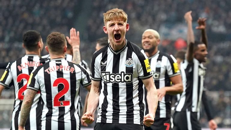 Newcastle United's Anthony Gordon, center, celebrates scoring a goal during...