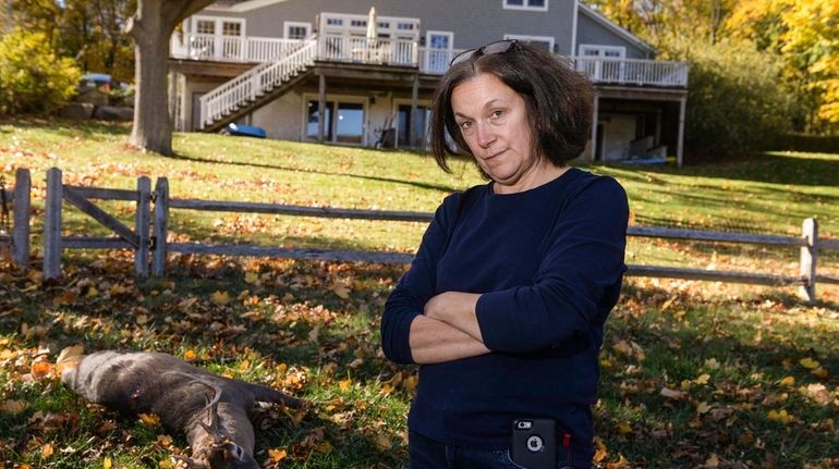 Cindy Gavel of Asharoken stands near a hunted deer on...