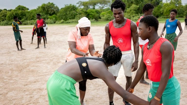 Coach Isabelle Sambou, 43 years old, two-time Olympian and nine-time...